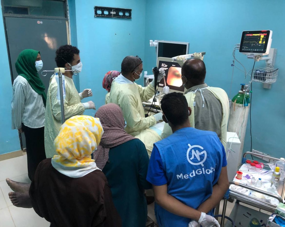 Healthcare professionals gather around a patient during an endoscopic procedure as part of MedGlobal’s Resiliency Medical Mission in Khartoum, Sudan.