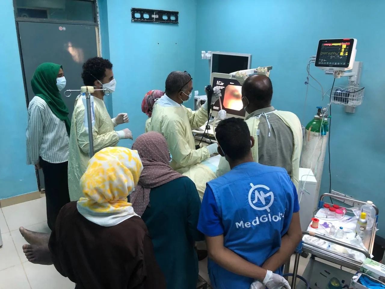 Healthcare professionals gather around a patient during an endoscopic procedure as part of MedGlobal’s Resiliency Medical Mission in Khartoum, Sudan.